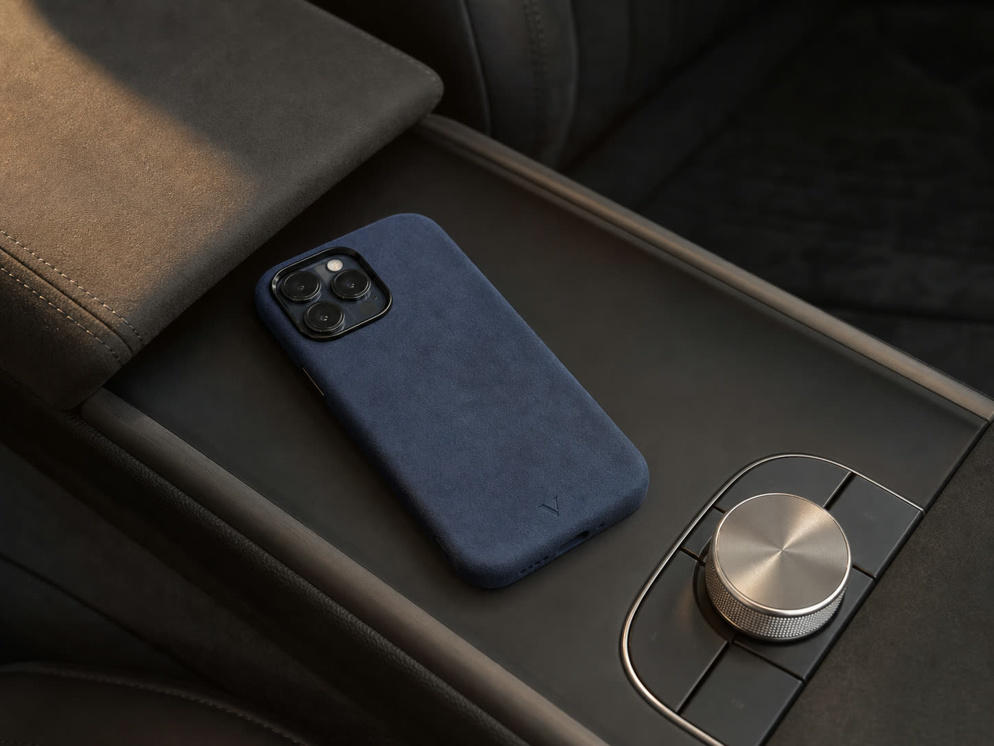 Navy Virela phone case in a refined car interior