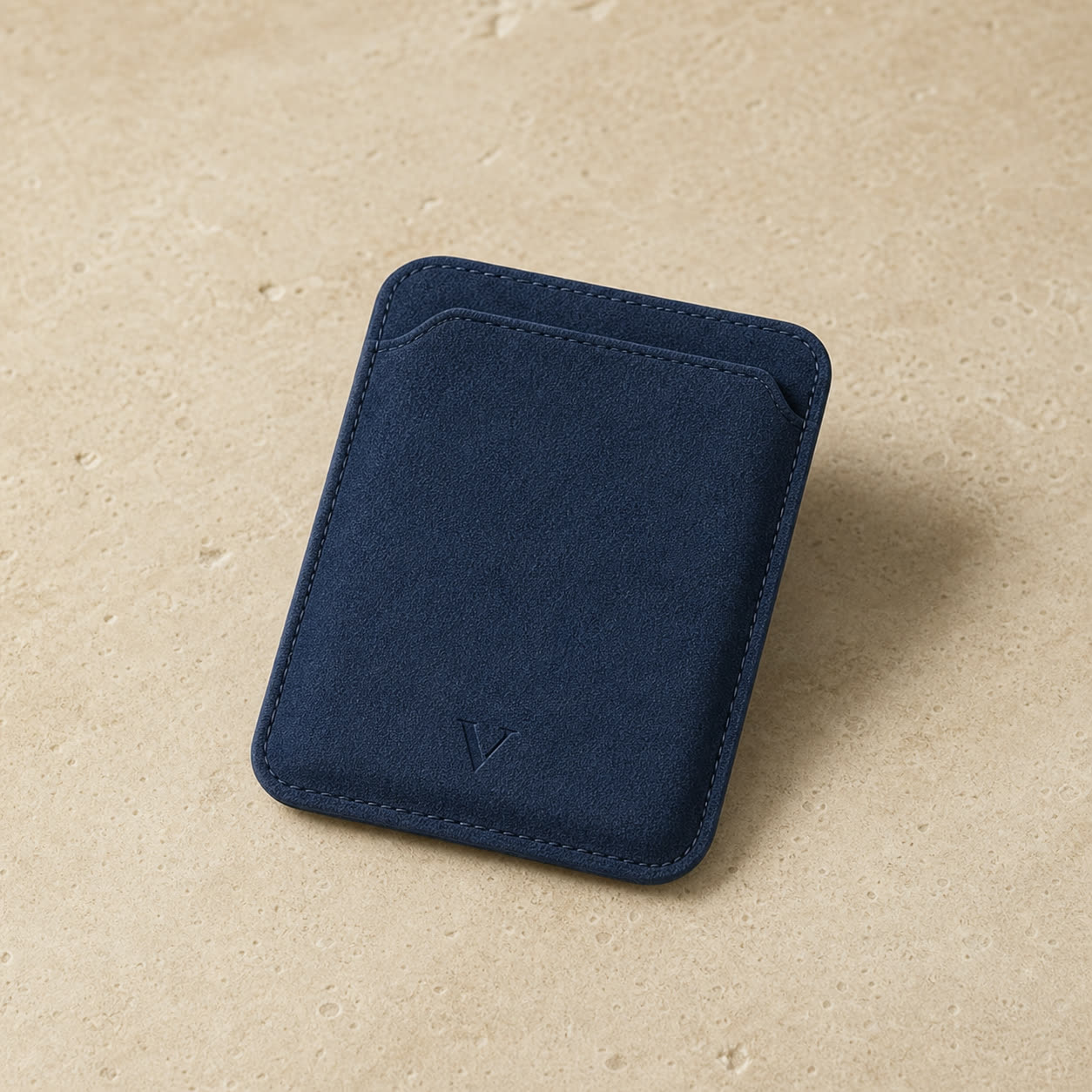 Navy Virela MagSafe wallet with a subtle bottom-center engraved V